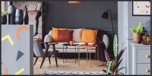 bachelor pad painted with dark grey walls, and accented in orange, light grey, and yellow pops of colour.