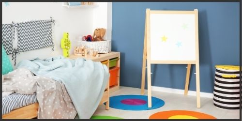 kids room with a blue accent wall, and lots of bright and fun colors.